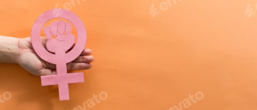 Preview: Shot of female hands holding a symbol of women's power - International women's day