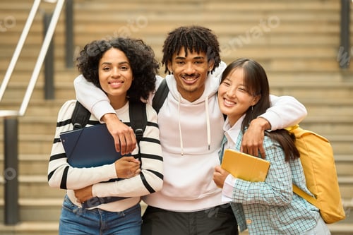 Preview: Three young students with backpacks and books looking at camera