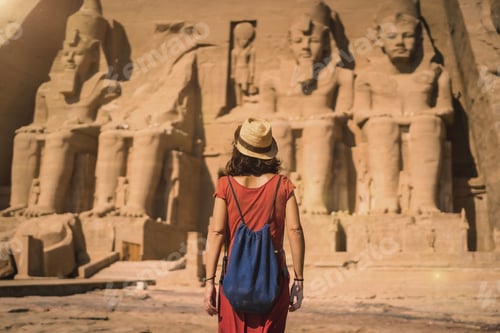 Preview: A young tourist in a red dress entering the Abu Simbel Temple in southern Egypt
