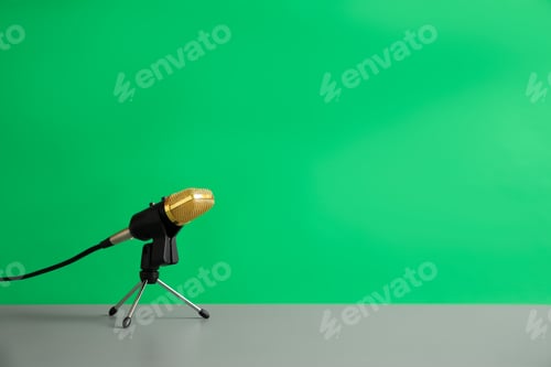 Preview: Microphone on table against green background, space for text. Journalist's work