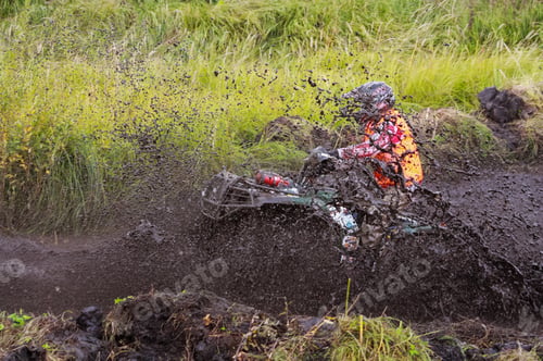 Preview: athlete on a quad bike rides in the mud
