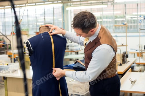 Preview: Tailor measuring jacket in his workshop