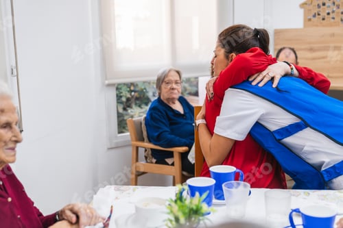 Preview: Nurse comforting elderly resident in care facility