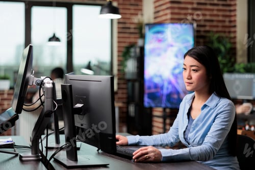Preview: Creative agency employee working on developing digital project while sitting at desk.