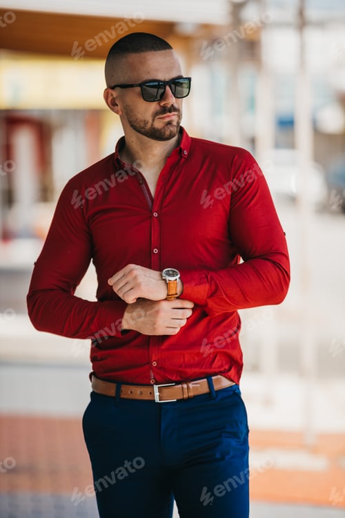 Preview: Man Adjusting Cuff in Urban Setting Sunlight