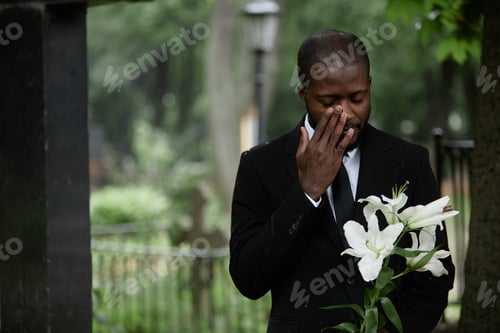 Preview: Grieving Black Man in Funeral Suit Crying at Graveyard