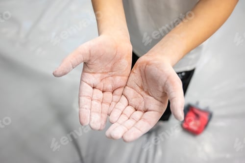 Preview: Close Up of Climber Chalked Hands Covered with White Magnesium Powder for Better Grip at Sports Gym
