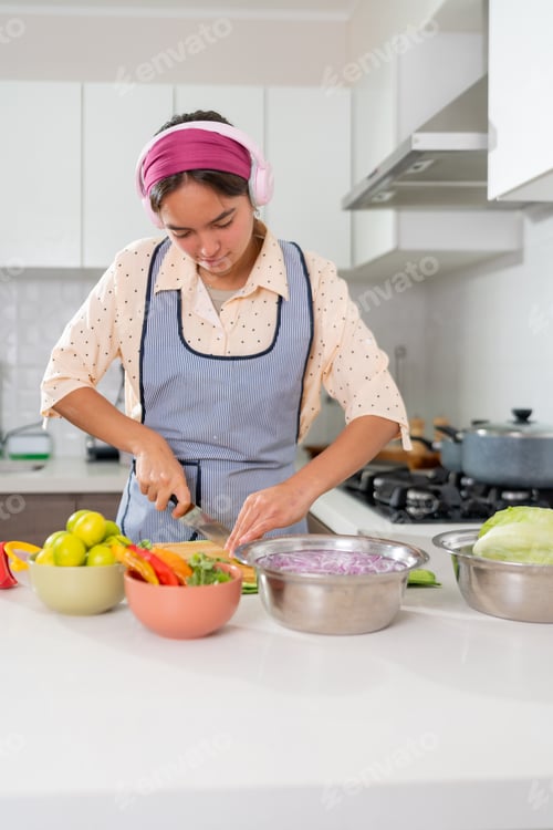 Preview: Young chef preparing ceviche, slicing ingredients in kitchen