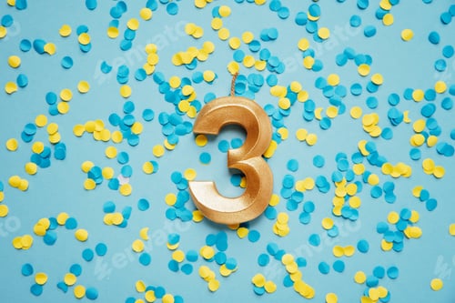 Preview: Number 3 three golden celebration birthday candle on yellow and blue confetti Background.