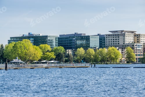 Preview: A View Of The Shoreline At Gene Coulon Park With Boat Anchored In Front.