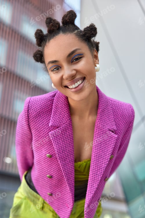 Preview: Fashionable smiling young woman dressed in pink jacket expresses positive emotions feels good walks