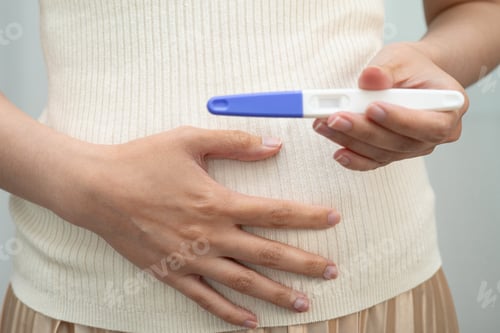 Preview: Asian holding pregnancy test for female of ovulation day, fetus
