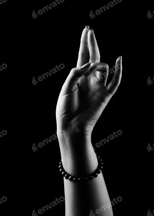 Preview: Vertical shot of a religious Christian hands sign on a black background