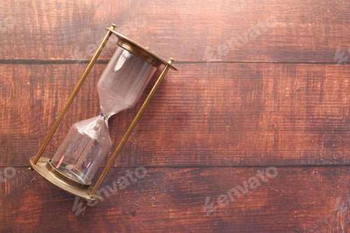 Preview: hourglass on table, sand flowing through the bulb of sandglass