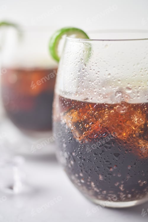 Preview: Cuba Libre in a glass with brown rum, cola, mint and lemon, caribbean drink for summer.