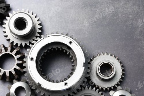 Preview: Different stainless steel gears on grey background, flat lay. Space for text