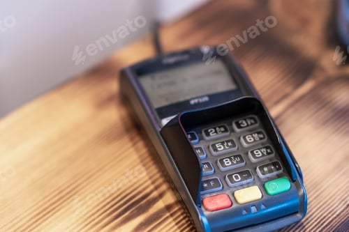 Preview: Terminal for cashless payment on a wooden background in a cafe