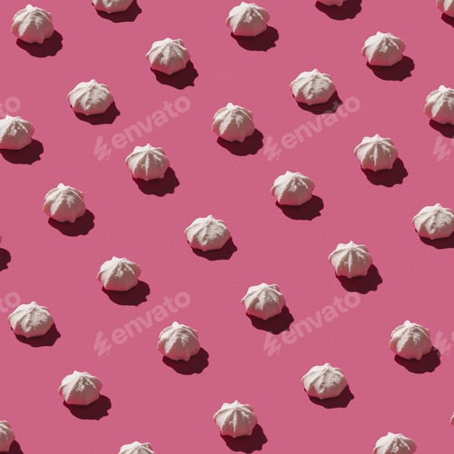 Preview: Pattern made of sweet meringues on pink background.