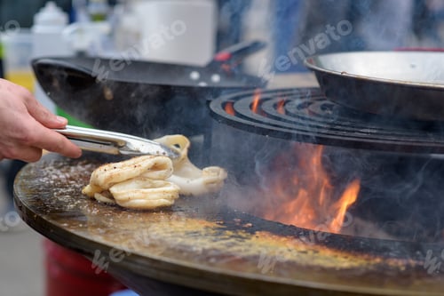 Preview: Octopus meat is prepared at the street food festival with smoke and fire.