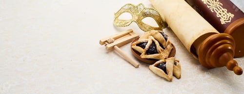Preview: Purim Celebrations. Golden mask, scroll, gragger, and hamantaschen on decorative background