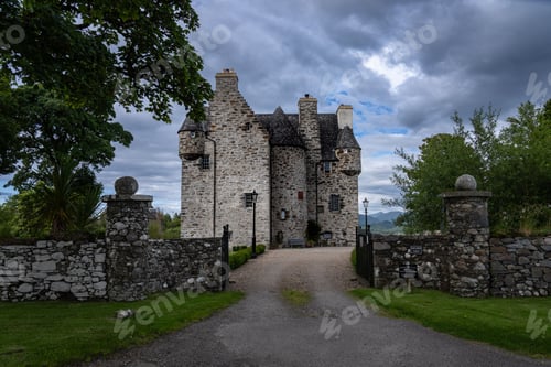 Preview: Historic stone castle with a cloudy sky and surrounding greenery in Scotland