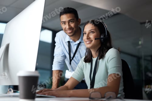 Preview: Shot of a young man and woman using a computer while working in a call centre