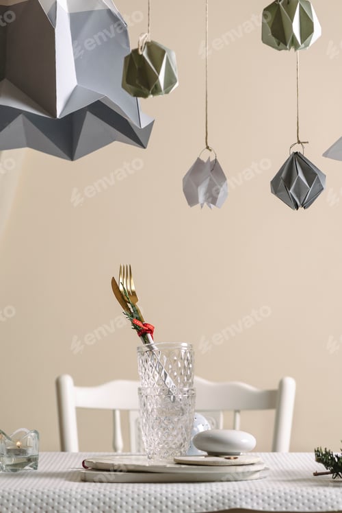 Preview: Plates and golden cutlery to mount the festive table, on the white table