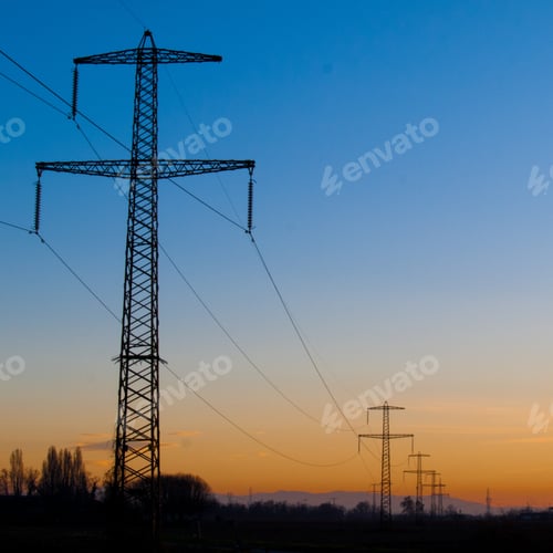 Preview: Low angle shot of transmission towers with beautiful scenery of sunset in a clear blue sky