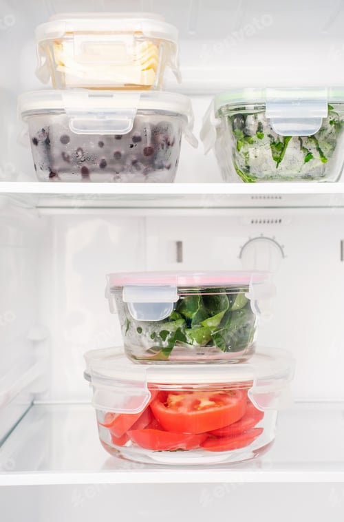 Preview: Vegetables and berries in glass boxes in the refrigerator close-up.