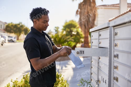 Preview: african american man checking community mail box in las vegas