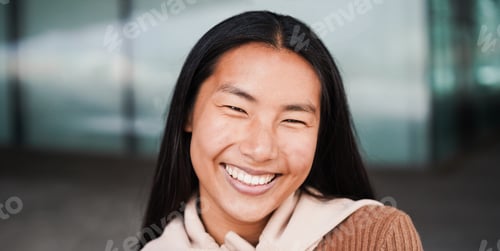 Preview: Asian girl smiling on camera during winter time outdoor