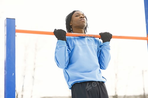 Preview: African american man doing exercise on winter day