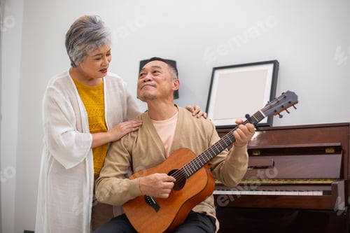 Preview: Happy asian senior elderly couple take it easy on retirement holidays playing guitar having fun