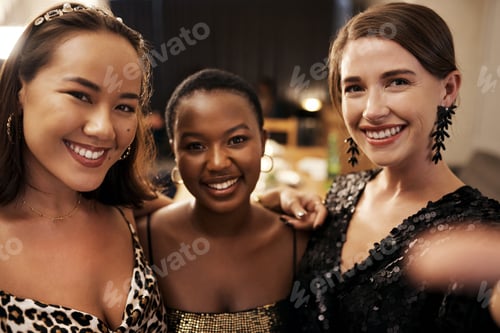 Preview: Shot of a diverse group of friends standing together and posing for a selfie during a dinner party