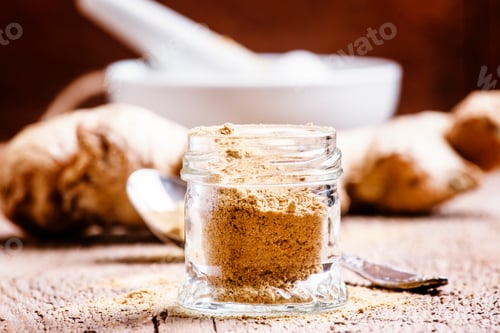 Preview: Ground ginger in a glass jar and fresh ginger root