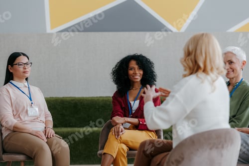 Preview: Group of mature women listening to speaker while visiting business conference