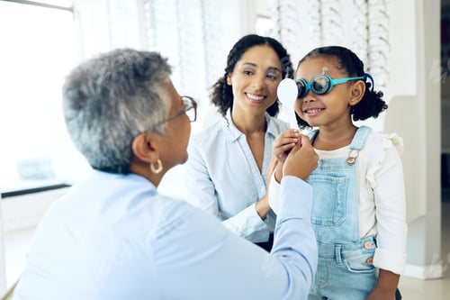 Preview: Eye exam, optometry and child with senior woman optometrist at clinic for vision check. Eyesight, g