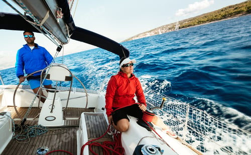 Preview: Attractive strong woman sailing with her boat