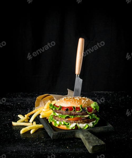 Preview: Burger with a knife and fries.