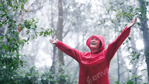 Preview: Joyful young woman breathing pure air in a lush forest