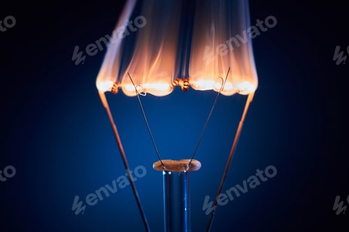 Preview: Electric bulb lamp with a burning spiral on a black background