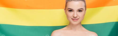 Preview: woman with naked shoulders smiling at camera near lgbt flag on background, banner