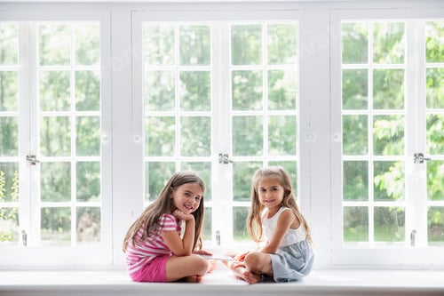 Preview: Two girls playing, sharing a digital tablet.