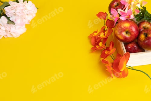 Preview: Group of red apples in wooden box on yellow background