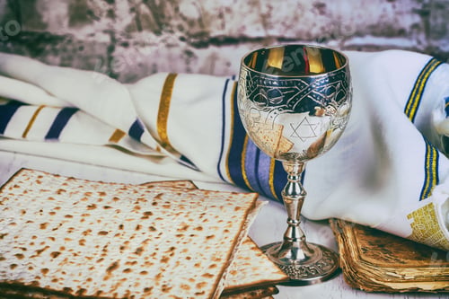 Preview: Matzo for Passover with metal tray and wine on table close up