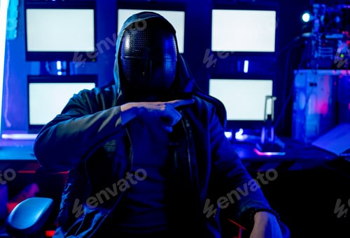 Preview: Man with black mask use hand to show sign of killer in front of camera and white monitor as backgrou
