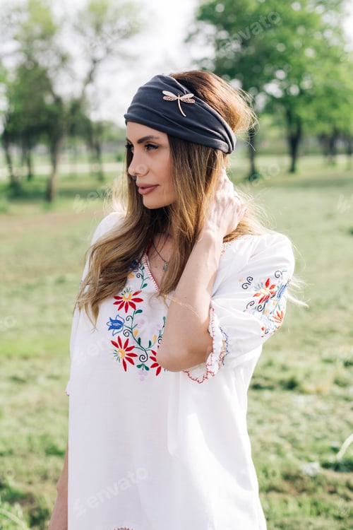 Preview: Portrait of young woman with turban on head and posing outdoor