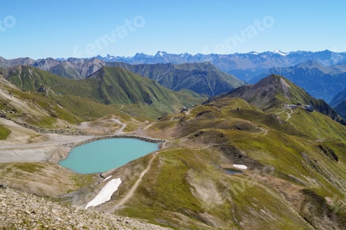 Preview: Alpine lake surrounded by green mountains. Silvretta High Alpine Road, Switzerland.
