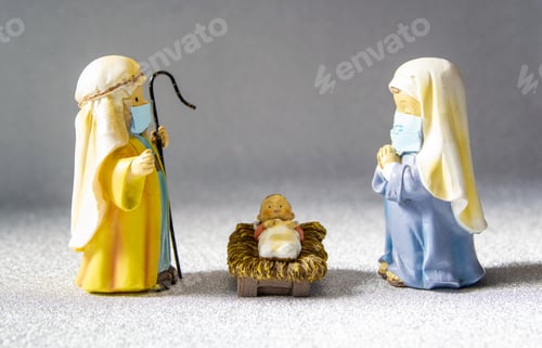 Preview: Closeup of miniature Virgin Mary, Joseph, and baby Jesus wearing masks