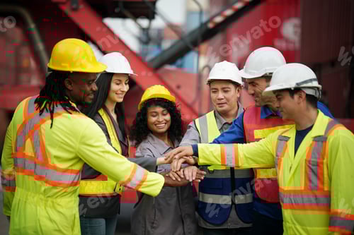 Preview: Team of workers celebrating success at a shipping yard during the day